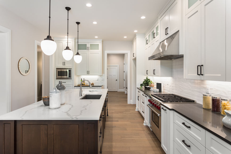 Renovated kitchen with new cabinets and wood flooring by Woodward Renovations Inc.